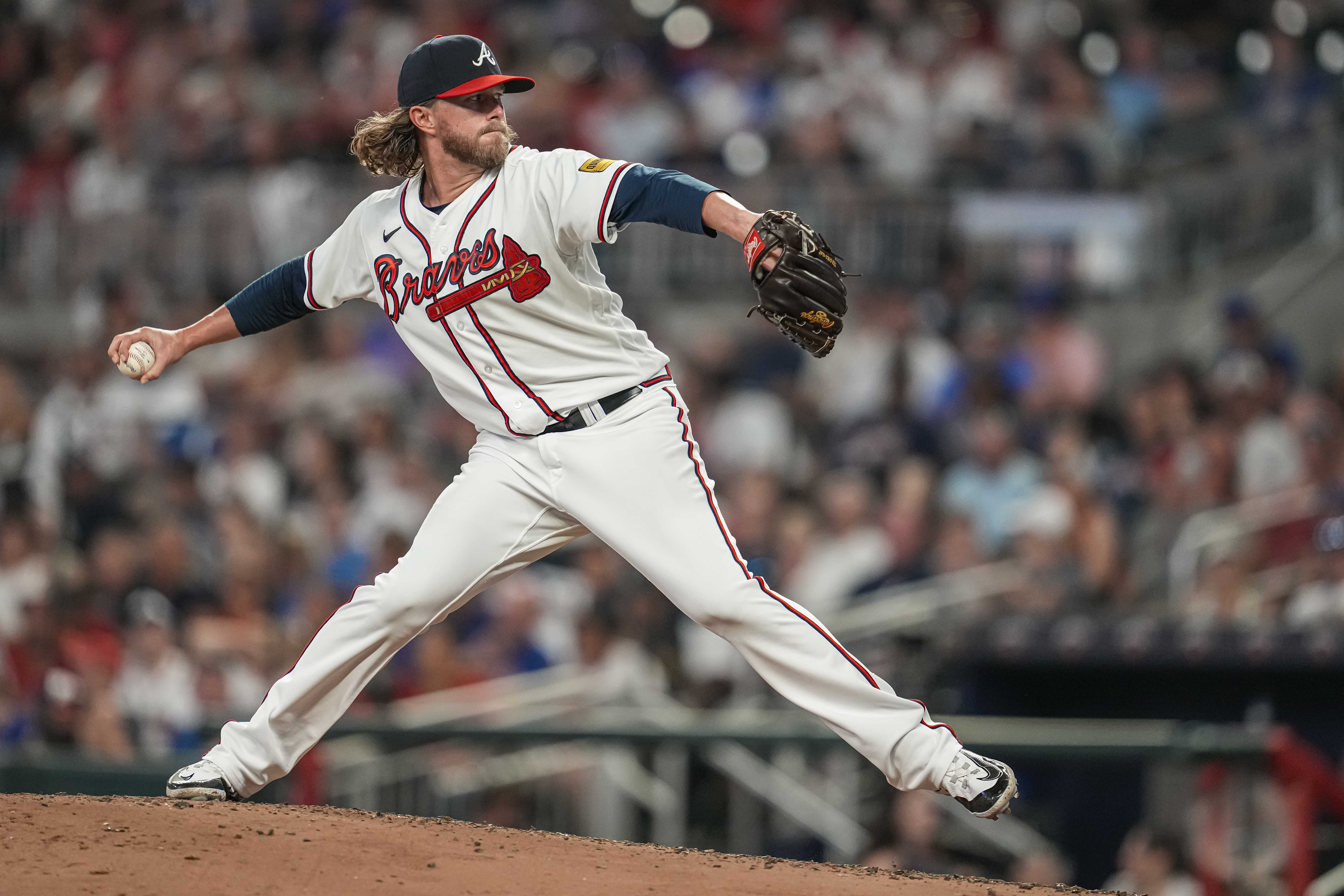 Aug 22, 2023; Cumberland, Georgia, USA; Atlanta Braves relief pitcher Pierce Johnson (38) pitches against the New York Mets during the sixth inning at Truist Park.